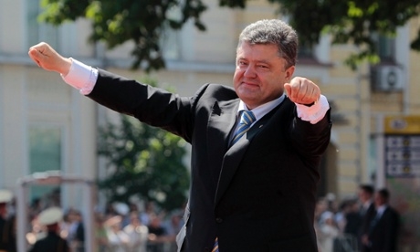 Ukrainian President Petro Poroshenko lifts his arms in greeting after his inauguration ceremony in Sophia Square in Kiev, Ukraine, in June