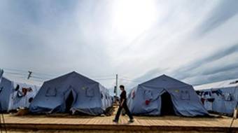 A refugee from eastern Ukraine walks in a refugee camp near the Russian city of Donetsk