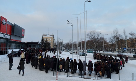 People wait for monthly humanitarian aid packages in front of the Donbass hockey stadium in Donetsk. Photograph: ANTONIO BRONIC/REUTERS